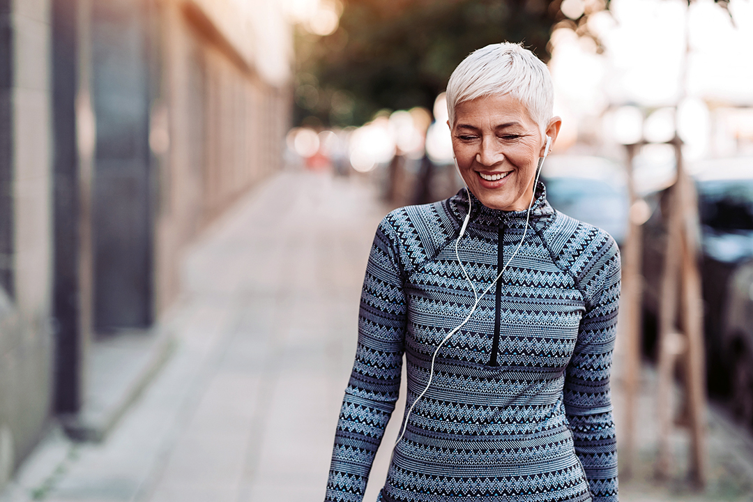 Senior female athlete walking outdoors in the city - Bone health - osteopororsis prevention