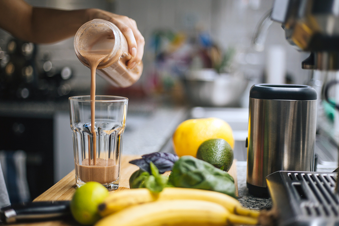 healthy protein - macronutrients - Woman preparing fresh fruit smoothie