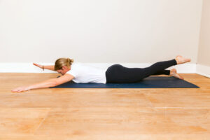 woman doing superman exercise strengthening back