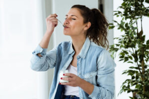 young woman eating yogurt