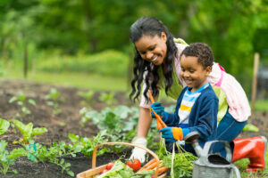 Vegetable gardens to grow with your kids - mom and son plant garden - AlignLife Healthy Living