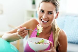 young woman eating healthy after workout to lose weight