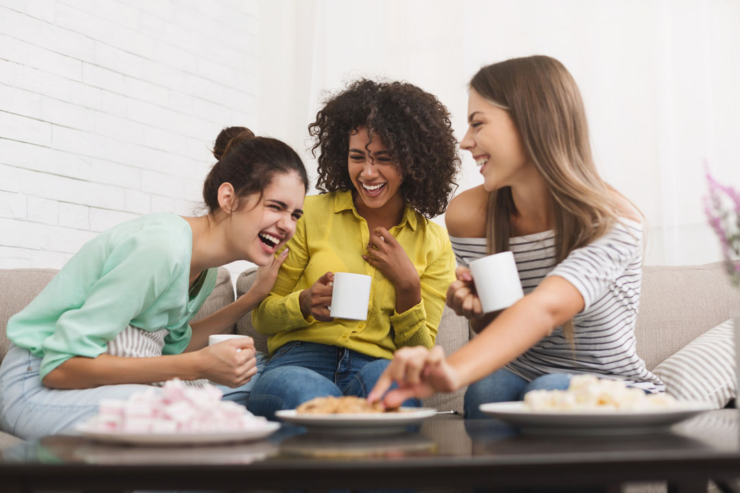 three woman talking and drinking tea