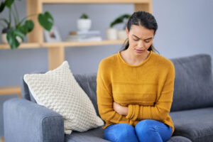 Woman on couch feeling bloated