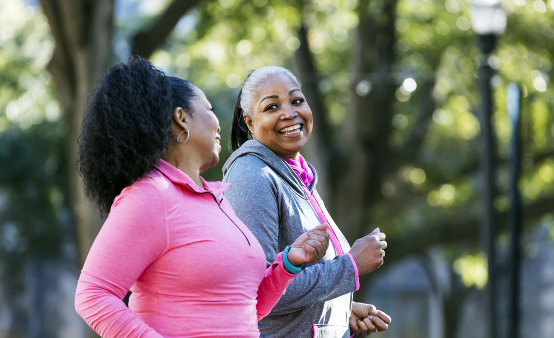 two women walking with good spinal posture