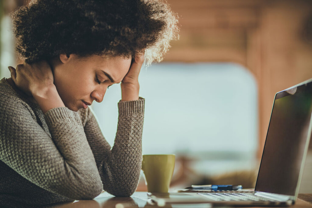 woman with headache from working on laptop