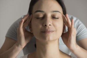 woman massaging away headache