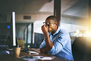 stressed man at work with headache