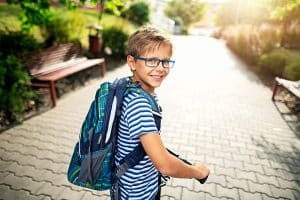 boy going to school with backpack on