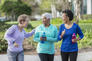 Mature group of women walking outdoors - fun fall outdoor exercises