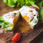 Tasty sandwich with poached egg and avocado
