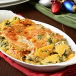 Butternut squash gratin with spinach and cheeses on a holiday table