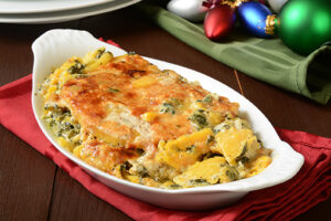 Butternut squash gratin with spinach and cheeses on a holiday table