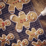 Decorating gingerbread Christmas Cookies with colorful icing