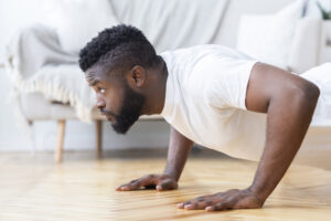 Young black man doing push ups - hiit exercises at home