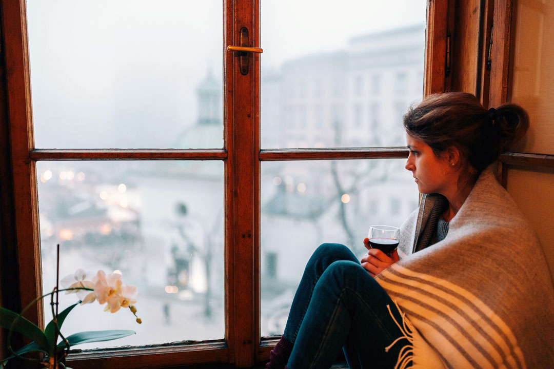 woman sitting by window - seasonal depression - gut health - alignlife