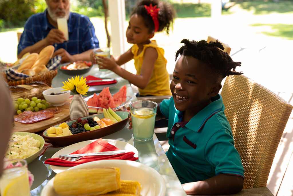 family eating at outdoor table