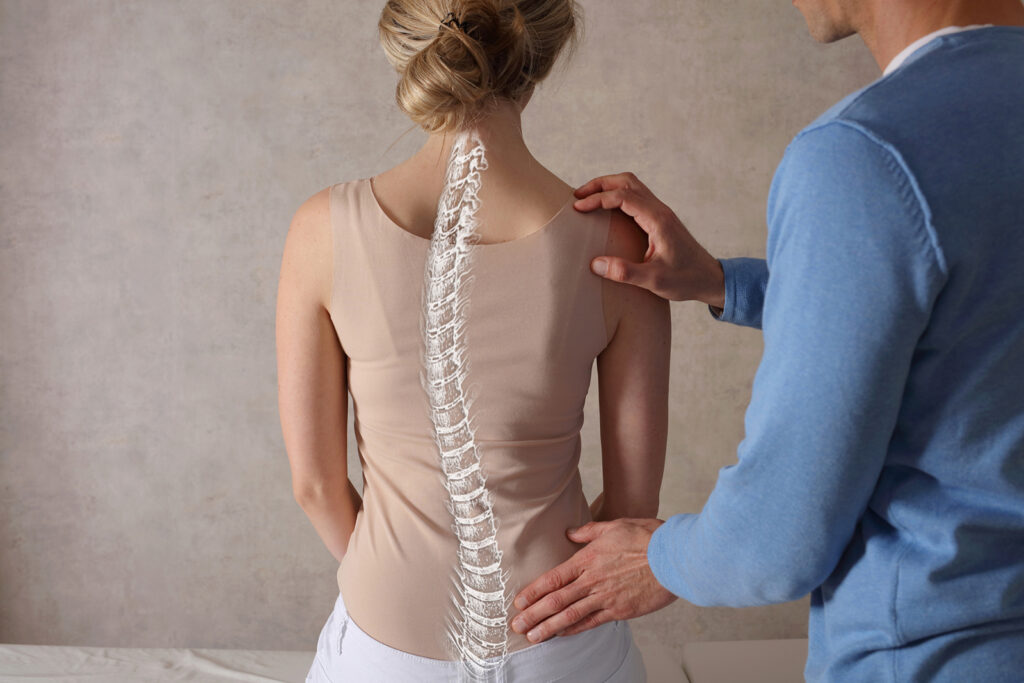 chiropractor checking a woman's spine