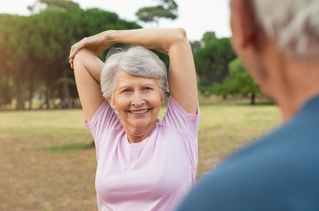 senior woman stretching arms and shoulders