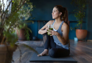 woman drinking green smoothing for all day energy