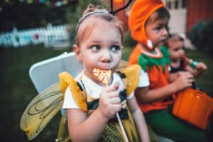 little girl eating halloween candy - sugar affects on body