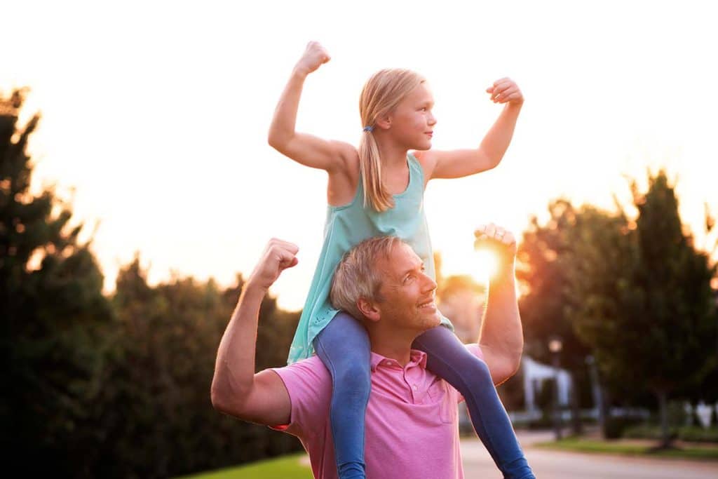dad and daughter flexing muscles