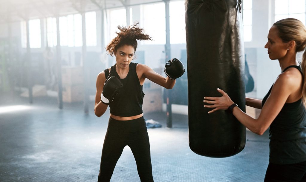 woman boxing with trainer