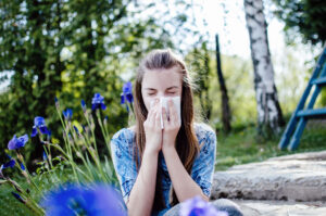 Teenage Girl with allergy blowing her nose