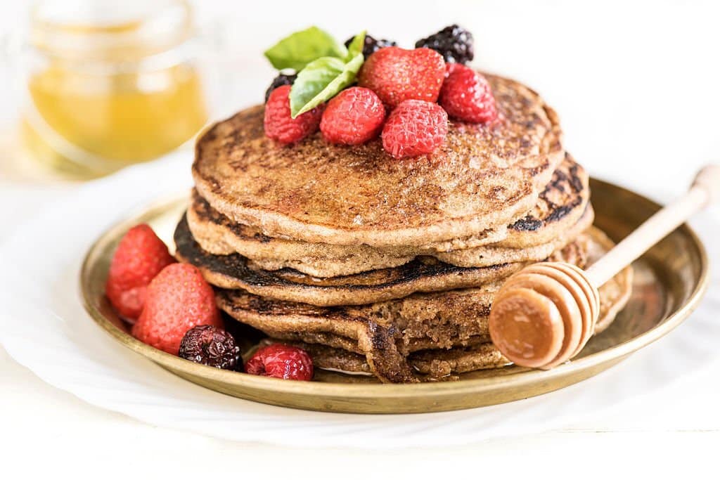 Buckwheat pancakes with berry fruit,honey and sugar powder