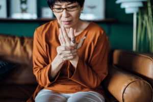 senior woman with arthritis pain in hands - how to avoid arthritis pain