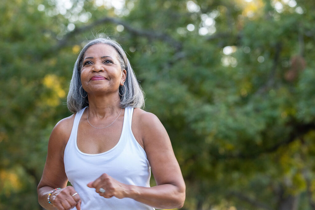 senior woman walking in park senior man with arthritis pain in shoulder - how to avoid arthritis pain