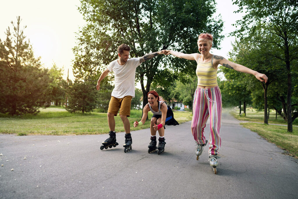 couple rollerblading on the street - summer exercise - active play