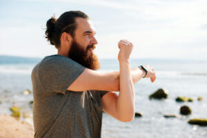 man stretching on the beach, mobility exercises