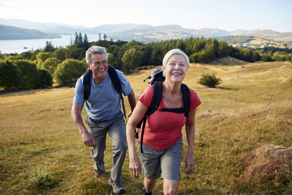 older couple hiking and improving mobility through exercise - heart healthy living