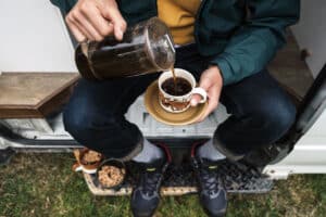 man pouring coffee outside