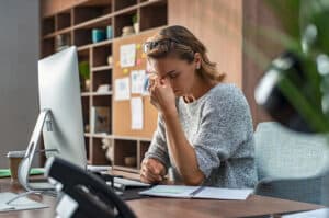 Business woman feeling overwhelmed and stressed