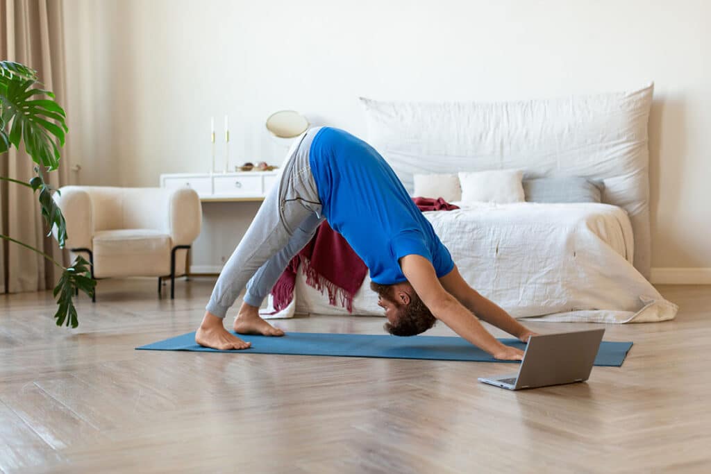 man doing downward dog - energy yoga