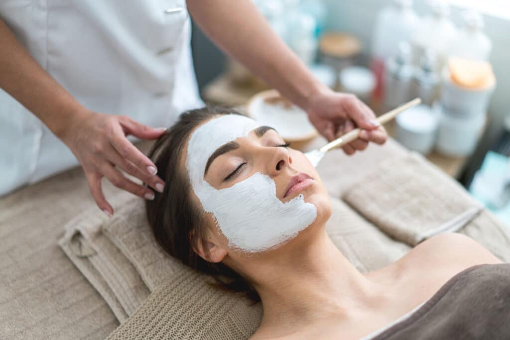 woman at spa getting a facemask