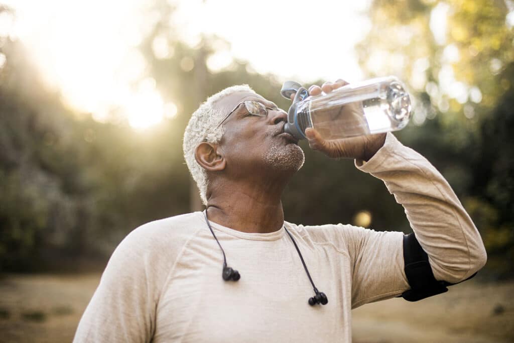 Senior African American Man Drinking Water