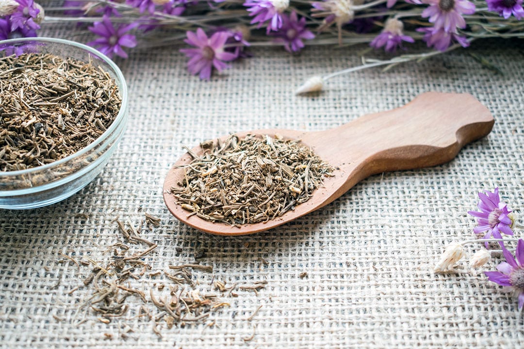 dried valerian root on a wooden spoon