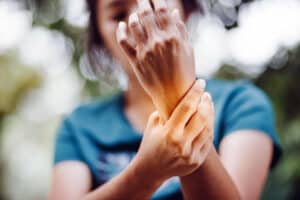 woman holding wrist with carpal tunnel pain