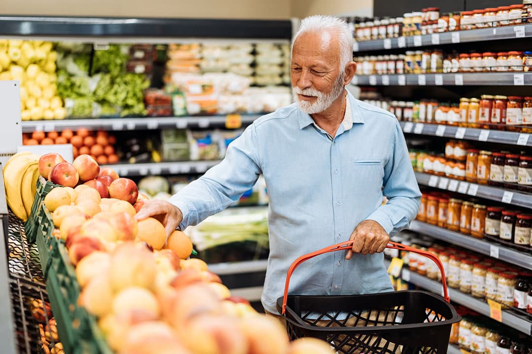 Retired man buying groceries - fruits and vegetables - clean eating diet