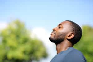 Man breathing deeply outside in the fresh air - Acupuncture for allergies