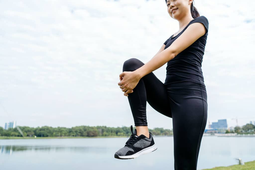 woman stretching at park