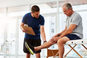 Senior Man having a foot and joint assessment - plantar fasciitis relief