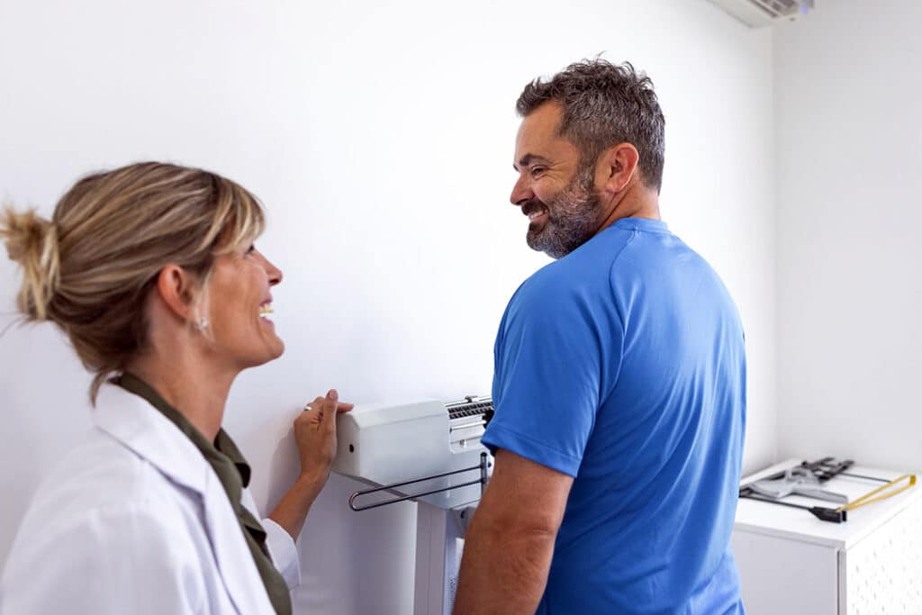 man working on weight loss goals with nutritionist