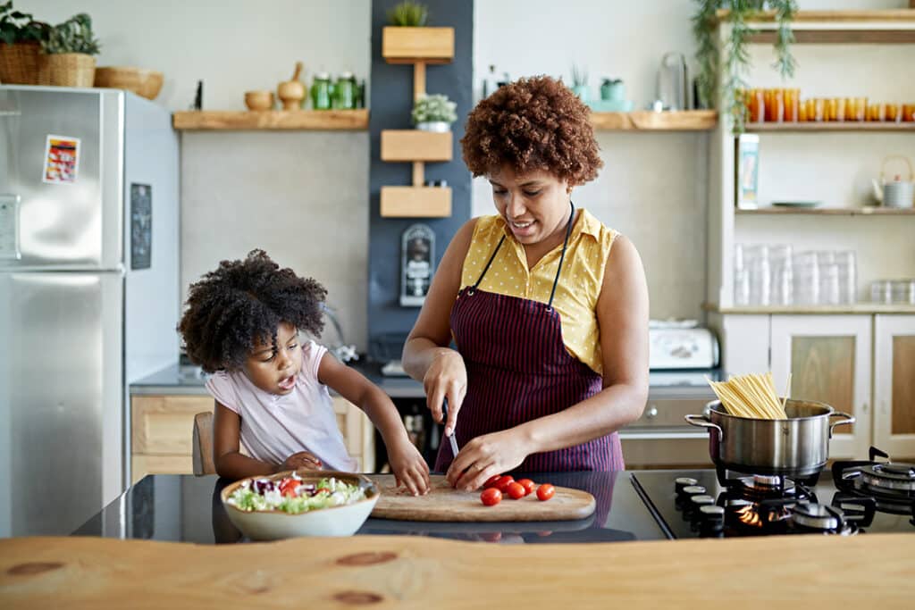 mom and daughter cooking a healthy meal