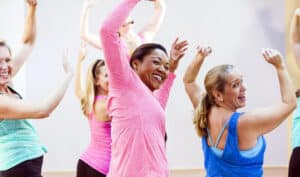 Group of multi-ethnic women in exercise class - weight bearing exercises