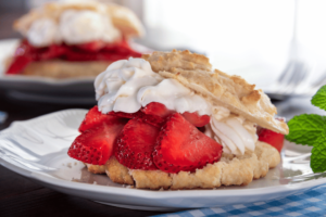 strawberry shortcake biscuit with fresh cut strawberries and whip cream