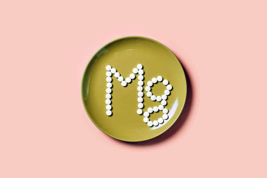 magnesium supplements on a plate forming an Mg - foods high in magnesium